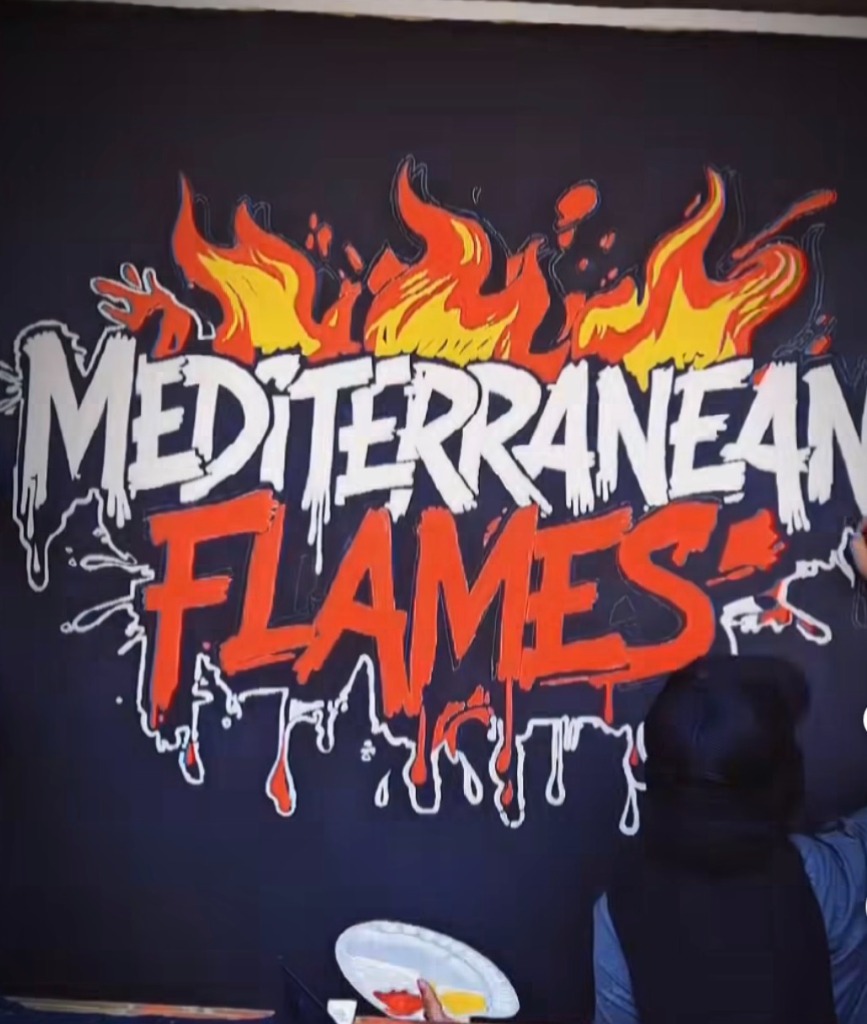 Mediterranean Flames mural painting — bold orange and white lettering with flames