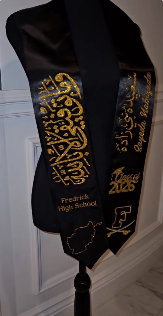 Black and gold graduation stole with gold glitter Arabic calligraphy and school emblem