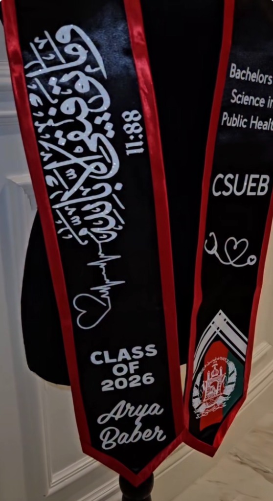 Black and red graduation stole with white Arabic calligraphy and Afghan flag