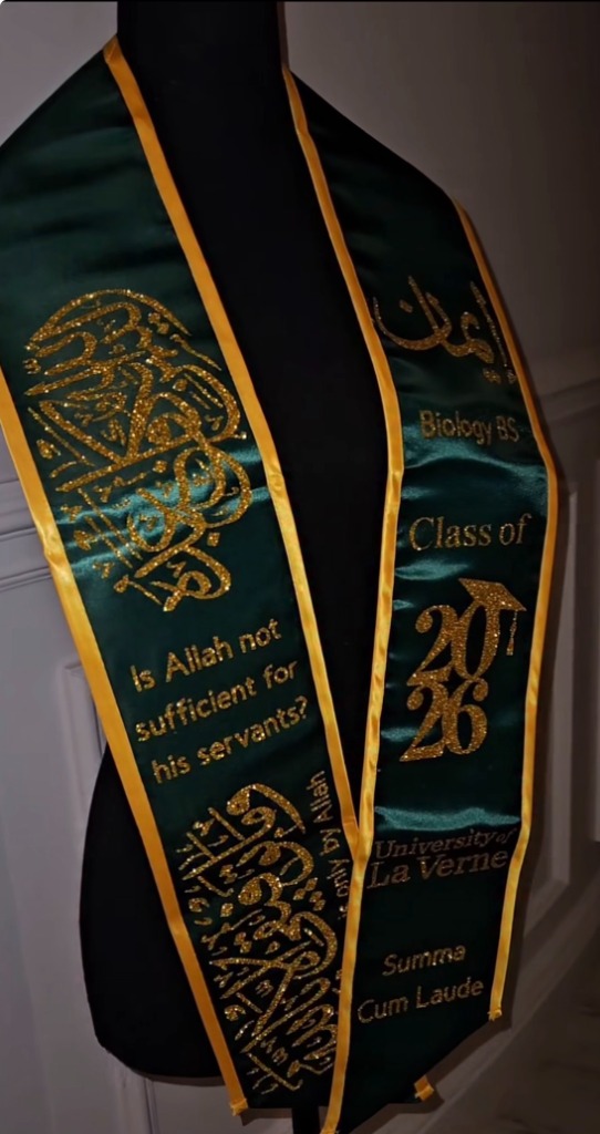 Forest green and gold graduation stole with gold Arabic calligraphy and university crest