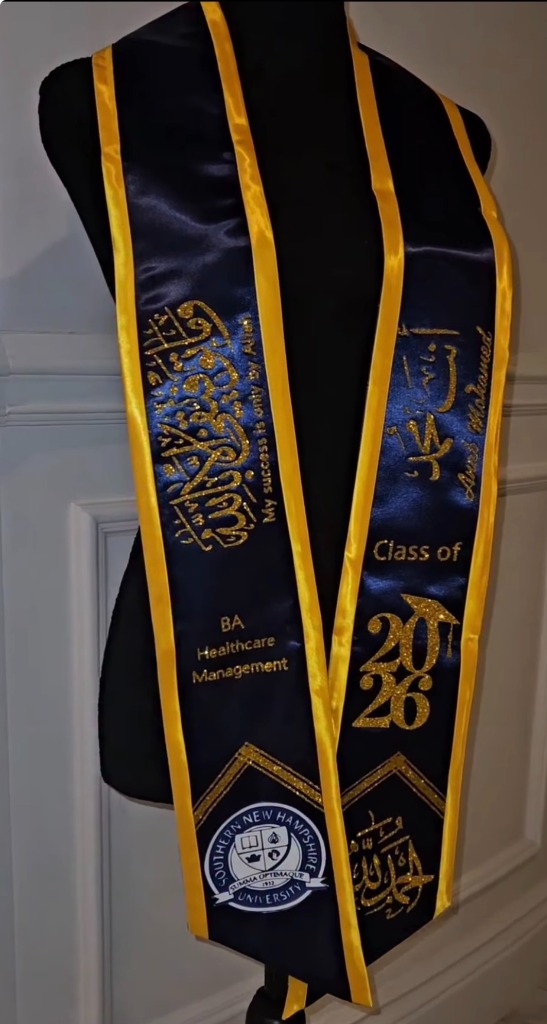 Navy and gold graduation stole with gold Arabic calligraphy and university seal