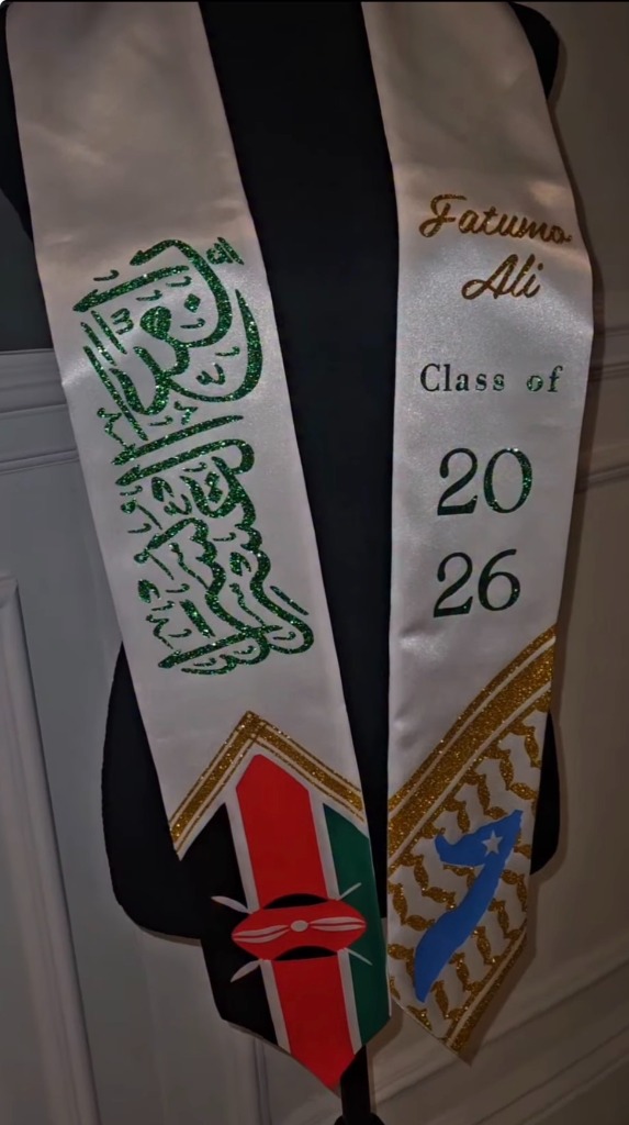 White graduation stole with gold Arabic calligraphy, RN emblem, and Kenya flag